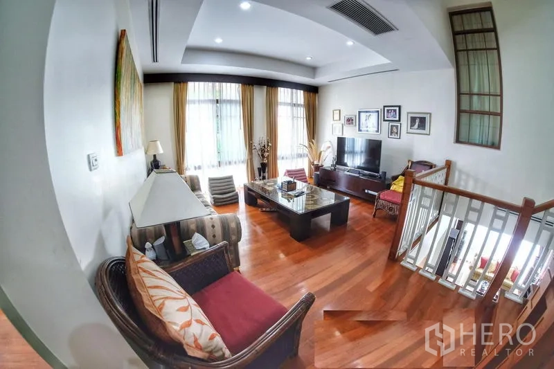 Detached House for rent in Watthana, Bangkok - Upstairs family room with TV area, large windows and warm timber flooring.