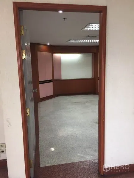Office Space for rent in Watthana, Bangkok - Private meeting room with built‑in wood panels, recessed lighting, and polished flooring.