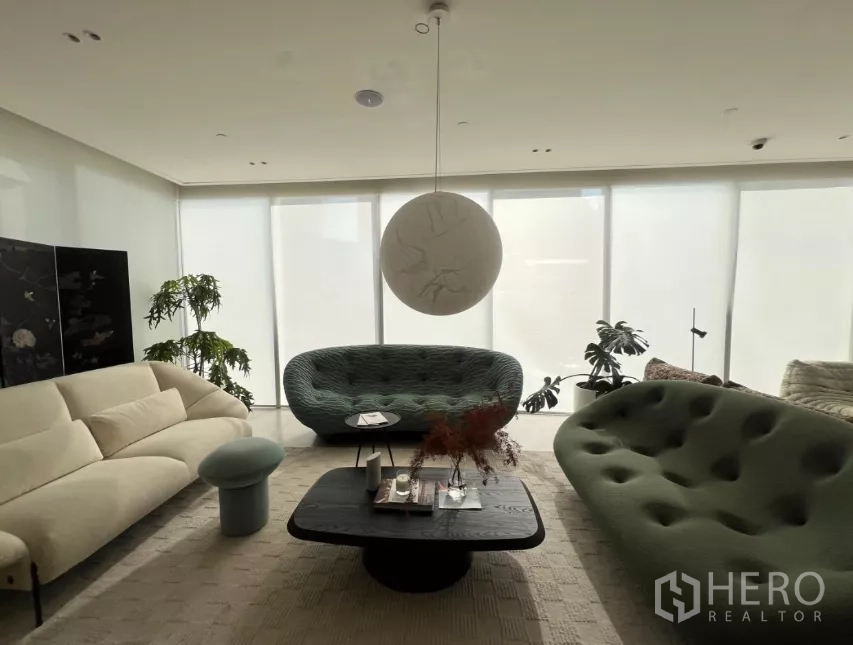 Retail Space for rent - Staged lounge area with modern sofas, coffee table and full-height windows.