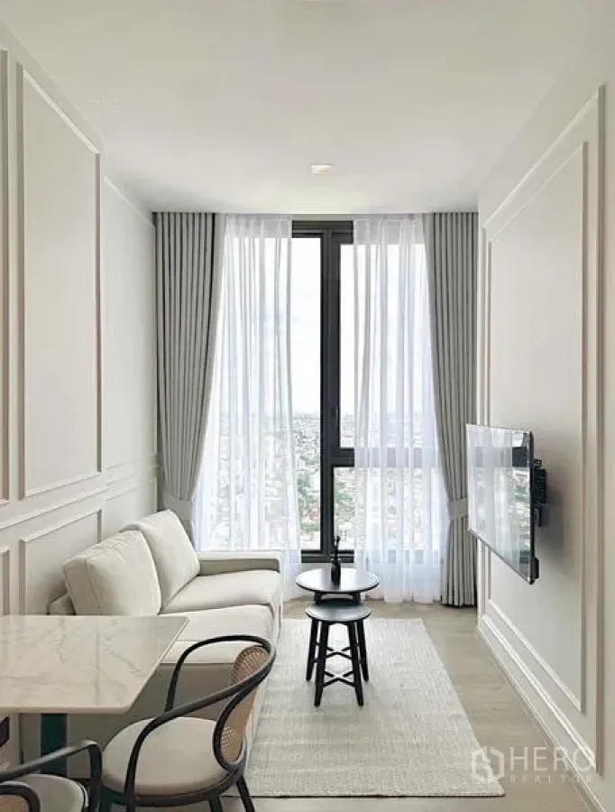 Condominium for rent - Open-plan living and dining corner with full-height windows and natural light.