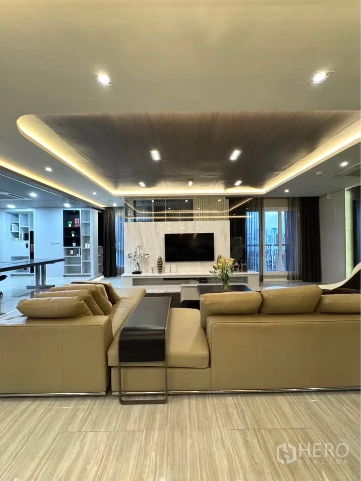 Condominium for rent or sale in Khlong Toei, Bangkok - Front view of the living room showcasing recessed lighting and marble-style floors.