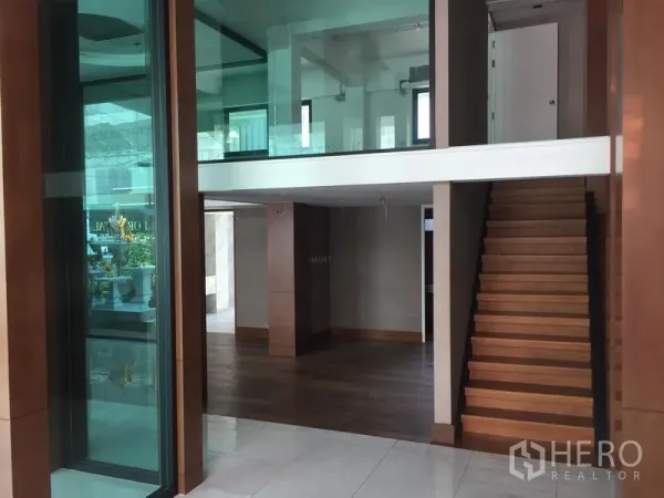 Retail Space for rent in Khlong Toei, Bangkok - Open-plan retail area featuring wooden staircase to mezzanine and glass partitions.
