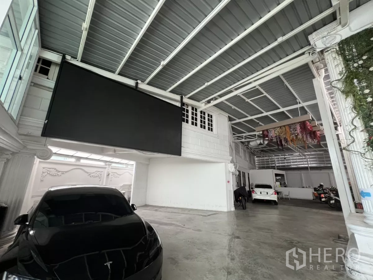 Retail Space for rent in Watthana, Bangkok - Indoor parking bay with cars and a large hanging screen.