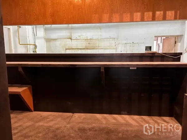 Retail Space for rent in Bang Rak, Bangkok - Long service counter connecting to a back-of-house kitchen area with utility connections and tiled walls.
