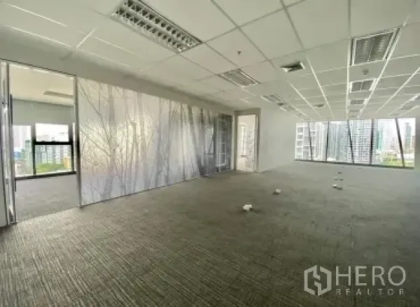 Office Space for rent - Spacious office with frosted glass partition, large windows and views of Bangkok’s business district.