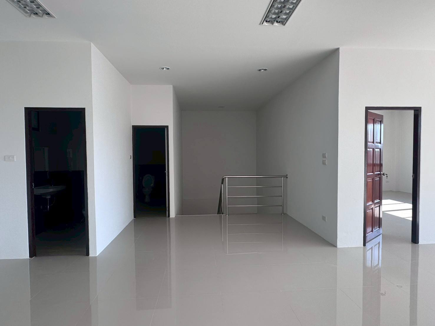 Factory for sale in Mueang Samut Sakhon, Samut Sakhon - Upper landing with multiple doorways, stainless handrail and polished tile floor.