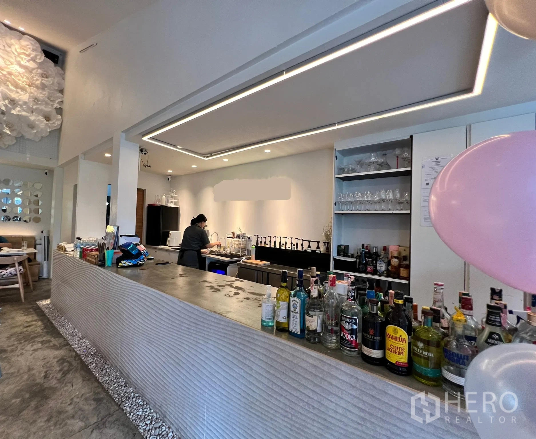 Retail Space for rent in Watthana, Bangkok - Modern service bar with bottle display, back shelving and recessed lighting in a clean retail space.