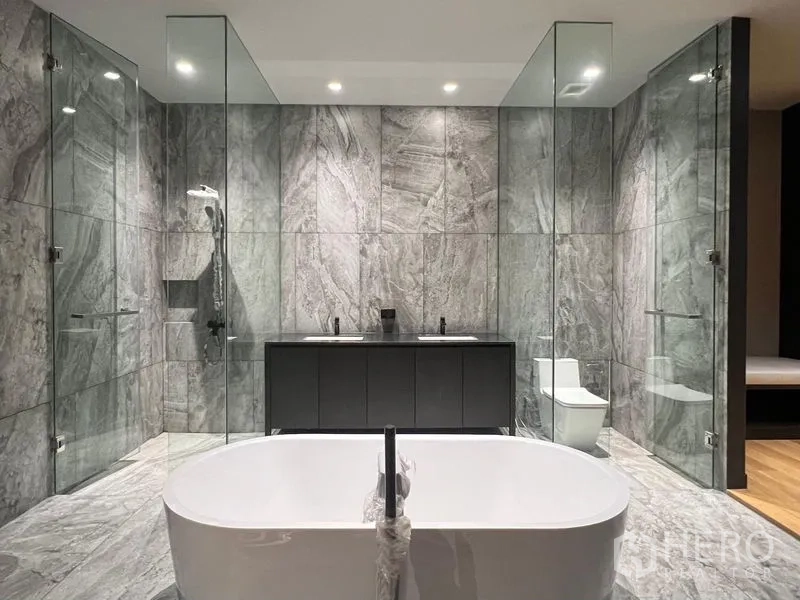Detached House for rent or sale in Bangkok - Luxurious marble bathroom with freestanding tub, double vanity, and glass showers.