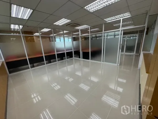 Office Space for rent in Suan Luang, Bangkok - Glass-partitioned meeting room with glossy tiled floor and overhead lighting.