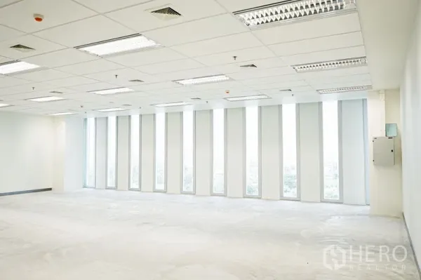 Office Space for rent in Bang Na, Bangkok - Bright open-plan office with floor-to-ceiling vertical windows, drop-ceiling lights and city views in Bang Na.