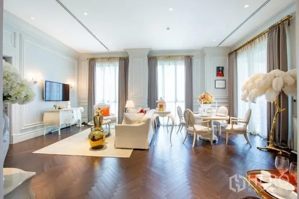 Condominium for sale in Pathum Wan, Bangkok - Open-plan living and dining area with herringbone wood floors and large curtained windows near BTS Phloen Chit.