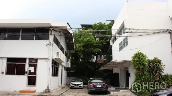 Office Space for rent in Suan Luang, Bangkok - Two white low-rise office buildings with on-site parking and greenery