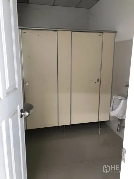 Factory for rent in Phra Nakhon Si Ayutthaya - Factory restroom with toilet cubicles and a wall-mounted urinal.