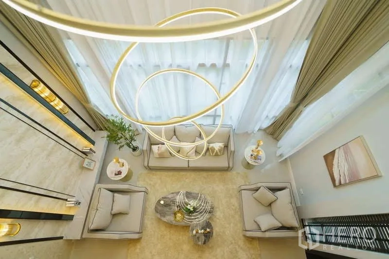 Detached House for rent or sale in Bang Phli, Samut Prakan - Double-height living room viewed from above with statement ring chandelier and tall windows.