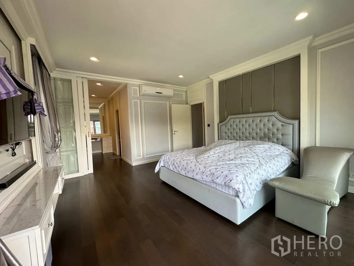Detached House for rent or sale in Lam Luk Ka, Pathum Thani - Master bedroom with tufted headboard and wardrobes.