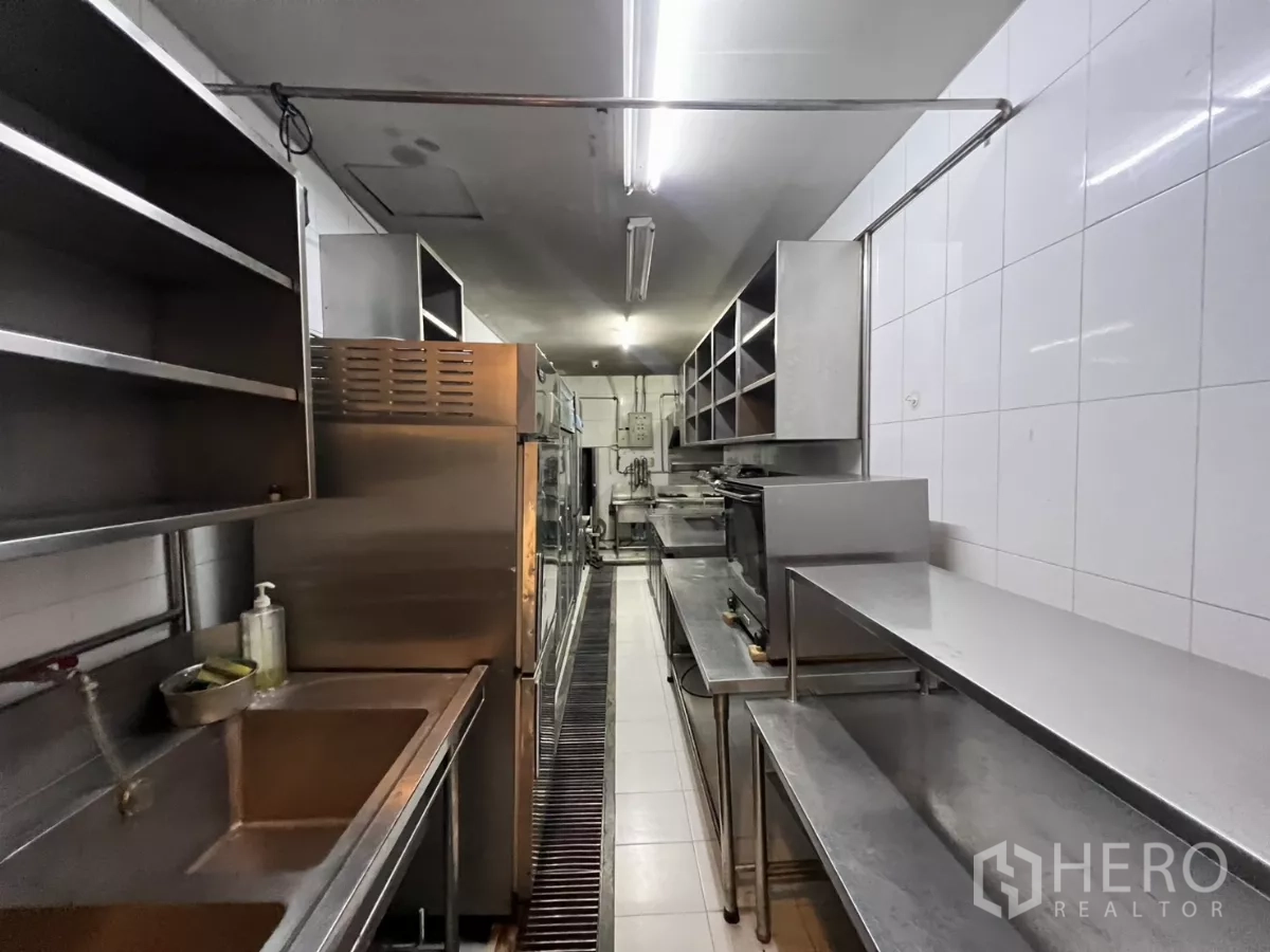 Retail Space for rent - Long galley kitchen with sinks, ovens and stainless preparation tables.