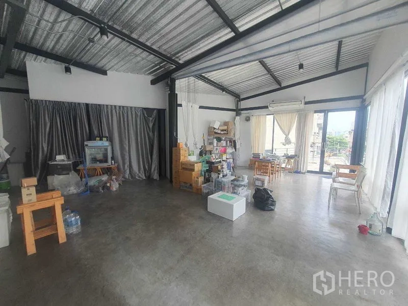 Retail Space for rent in Sathon, Bangkok - Spacious flexible retail floor with industrial ceiling, concrete flooring, and abundant daylight from multiple glass walls.