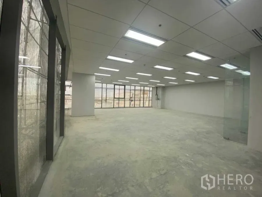 Office Space for rent in Phra Khanong, Bangkok - Wide corner office area with glass curtain walls and glass entry, ready for fit-out.