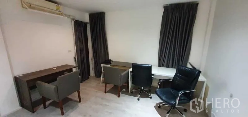Detached House for rent in Prawet, Bangkok - Home office with multiple desks and chairs beside curtained windows