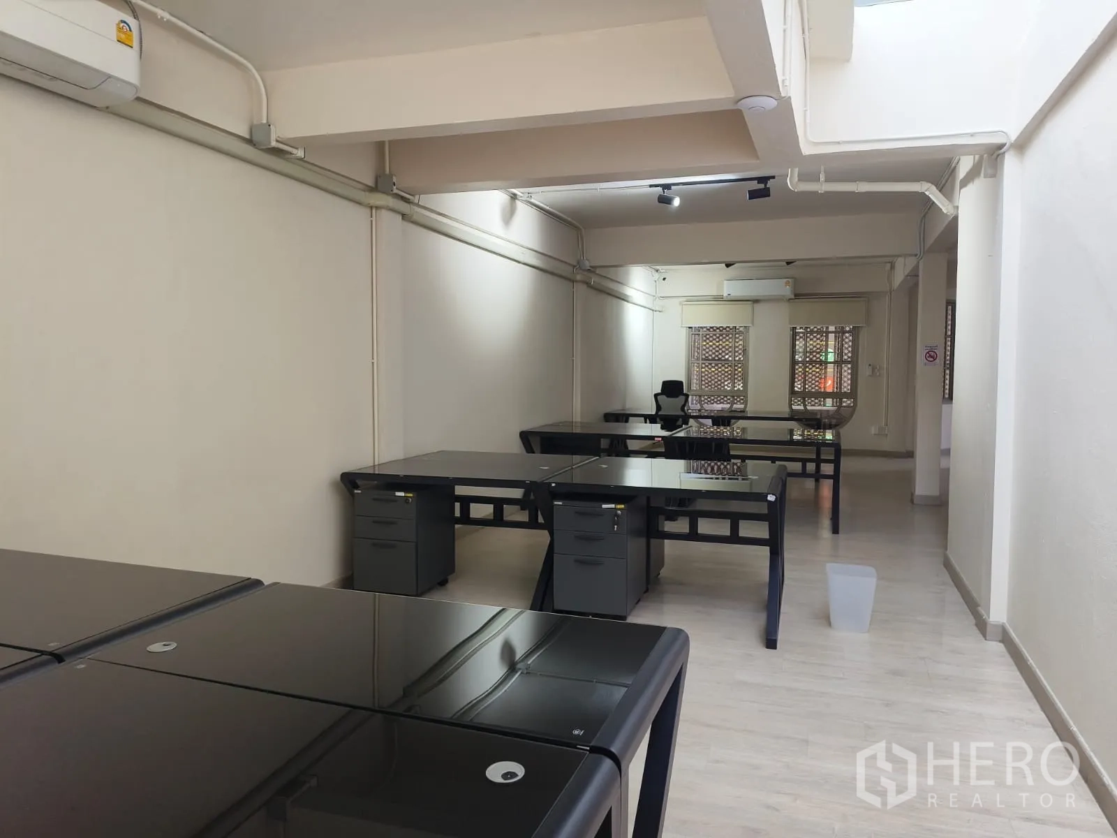 Shophouse for rent in Watthana, Bangkok - Open-plan office with multiple workstations, air-conditioning and large windows.