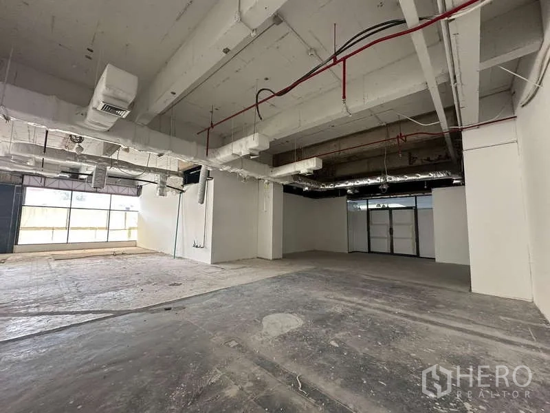 Office Space for rent - Spacious unfinished office with concrete floors, ducted air system and glazed frontage.