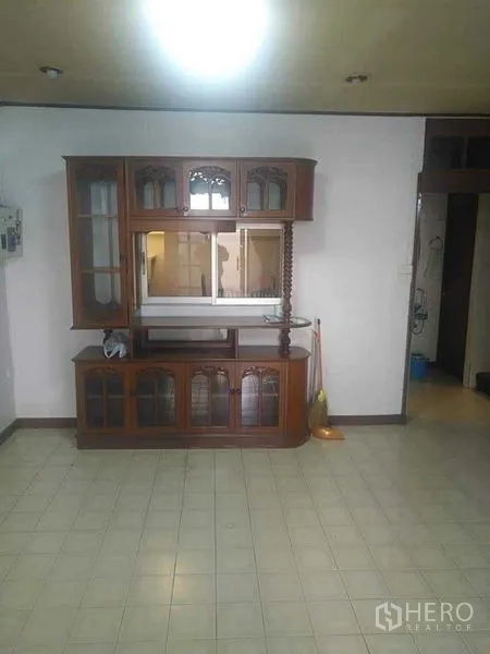 Townhouse for rent - Dining or family room featuring a vintage wooden display cabinet and tiled flooring.