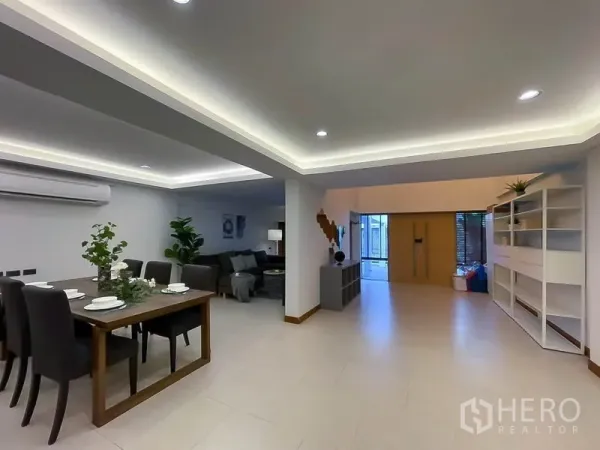 Townhouse for rent in Khlong Toei, Bangkok - Open-plan dining and living area with recessed lighting and shelving.