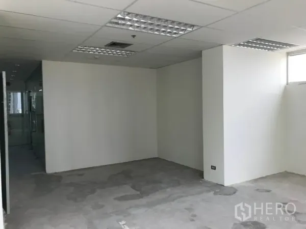 Office Space for rent in Khlong Toei, Bangkok - Compact enclosed workspace with white walls under grid ceiling lights.