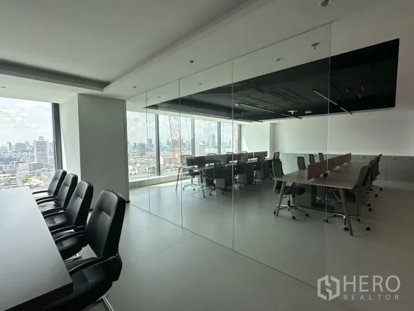 Office Space for rent in Din Daeng, Bangkok - Glass-partitioned office showing a conference room and workstations with skyline views.