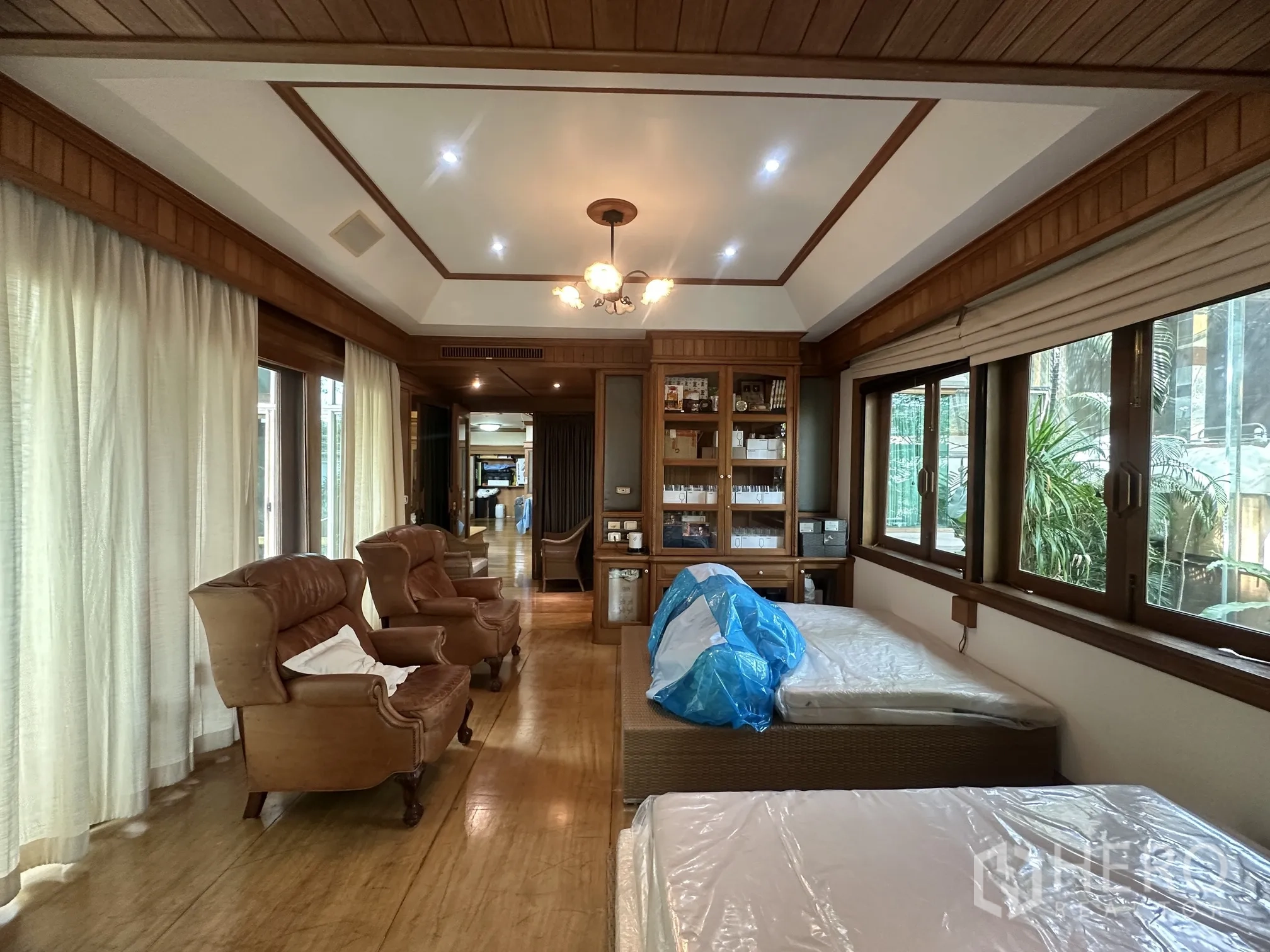 Detached House for rent in Lam Luk Ka, Pathum Thani - Bright bedroom with twin beds, armchairs, and curtain-lined windows.