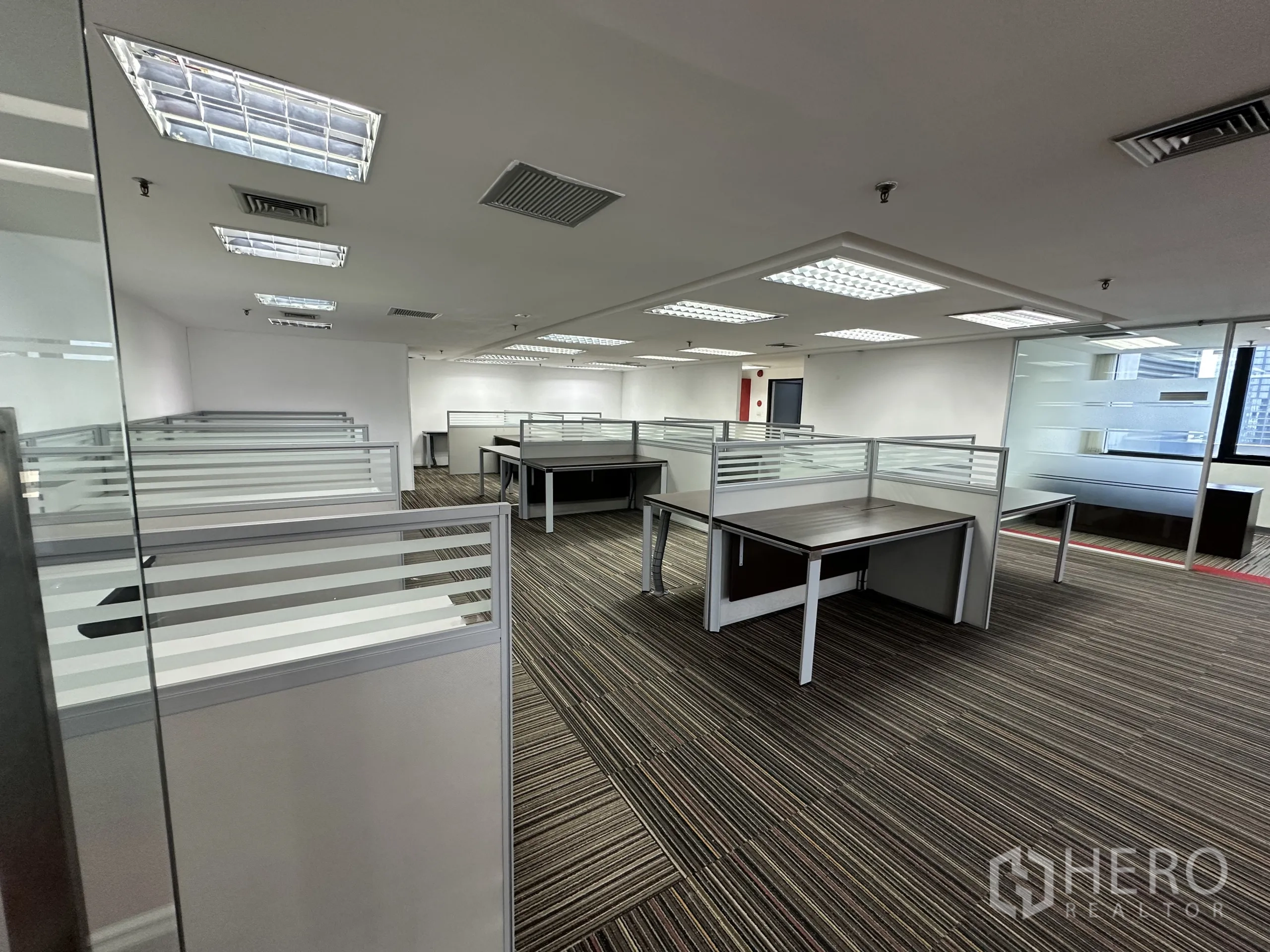 Office Space for rent in Watthana, Bangkok - Open-plan office with furnished cubicles, grid lighting and striped carpet.