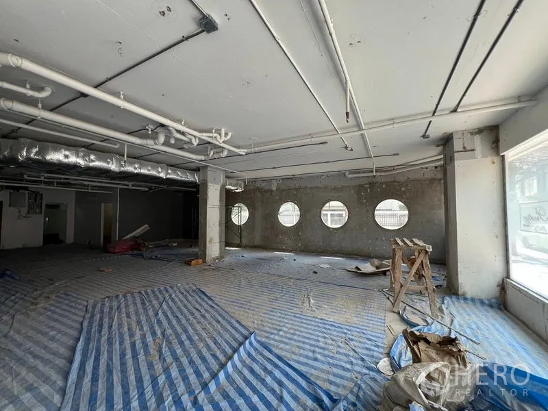 Retail Space for rent in Watthana, Bangkok - Large open hall with circular porthole-style windows and visible ductwork.