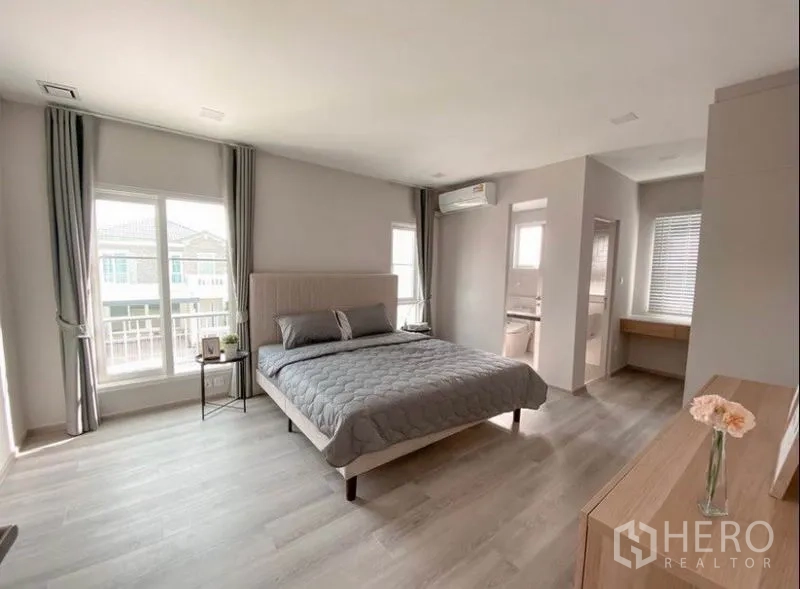 Detached House for rent in Prawet, Bangkok - Spacious master bedroom with en-suite bathroom and large windows.