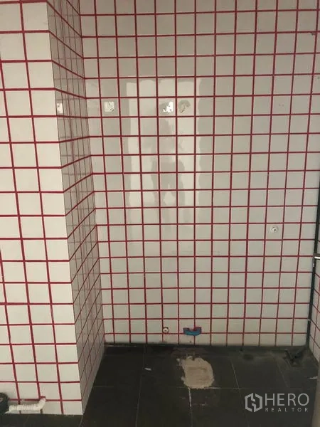 Retail Space for rent in Khlong Toei, Bangkok - Tiled utility wall with red grid and plumbing points, ideal for a pantry or wash area.