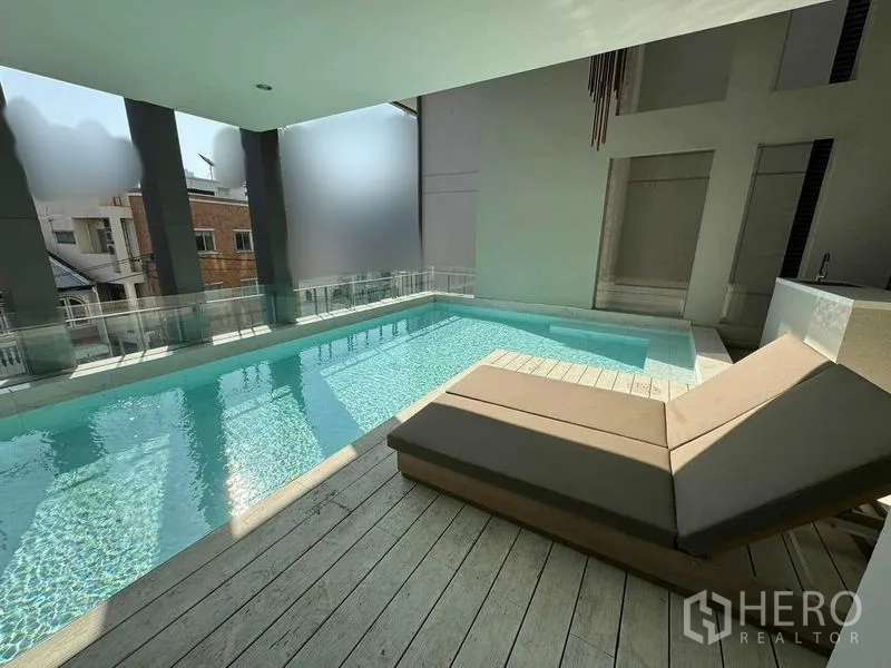 Townhouse for rent in Watthana, Bangkok - Private covered swimming pool with sundeck, lounger and glass balustrade.