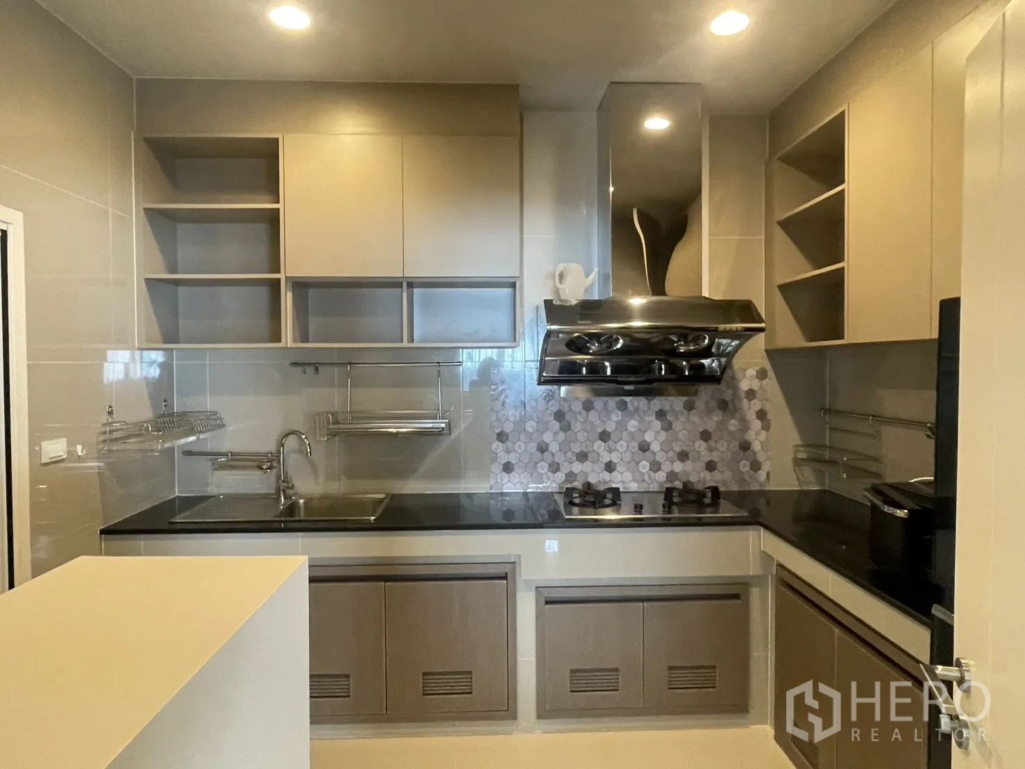 Detached House for rent or sale in Lam Luk Ka, Pathum Thani - Separate Thai kitchen with gas hob, powerful stainless range hood, open shelving and tile backsplash.