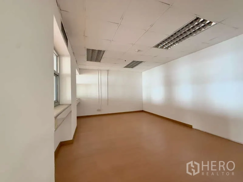 Office Space for rent in Chatuchak, Bangkok - Private office room with a long window ledge, white walls and recessed fluorescent lighting.