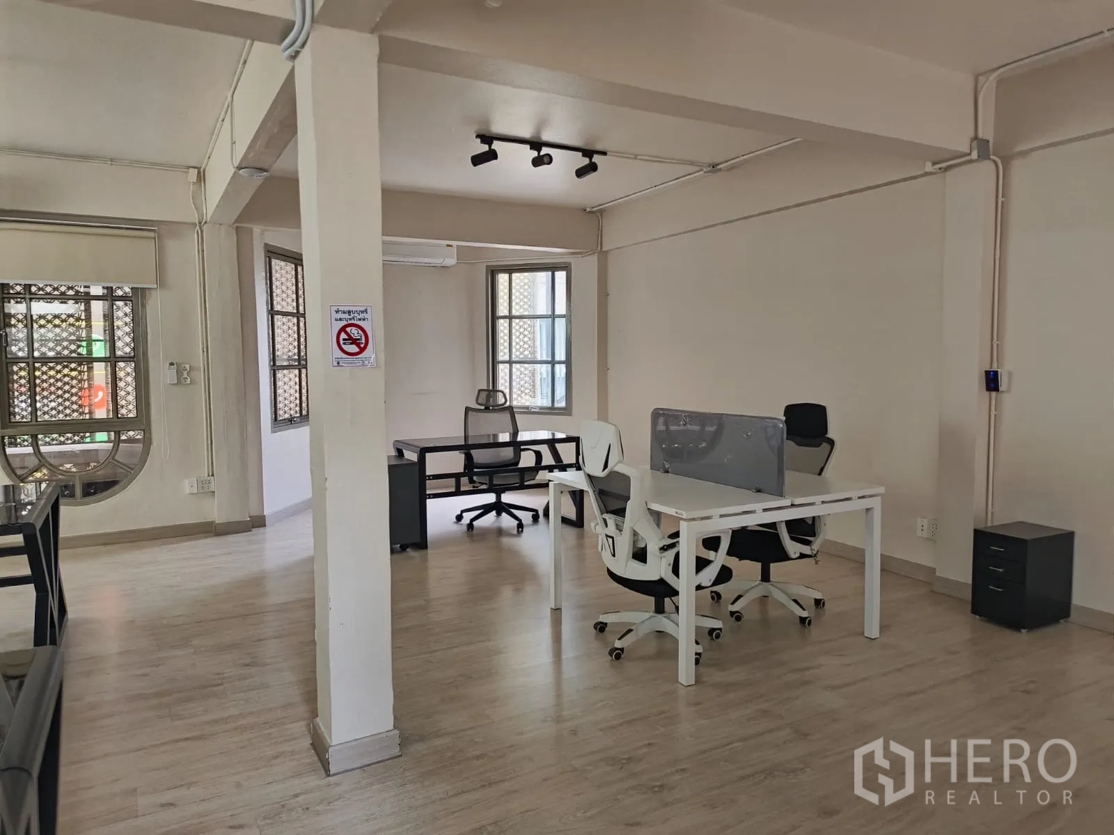 Shophouse for rent in Watthana, Bangkok - Office area with desks, track lighting and pale wood floors.