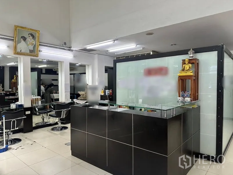 Shophouse for rent in Phra Khanong, Bangkok - Modern salon front desk and seating area inside a commercial shophouse.