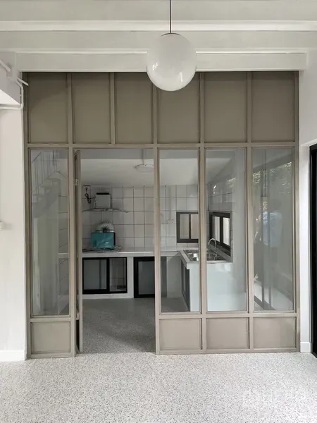 Home Office for rent in Khlong Toei, Bangkok - Glass partition opens to tiled pantry and sink in a light-flooded workspace
