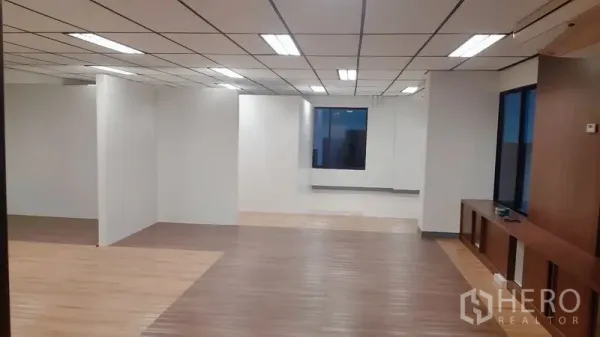 Office Space for rent in Chatuchak, Bangkok - Spacious office floor with mixed-tone wood flooring, bright ceiling lights, and partition walls.