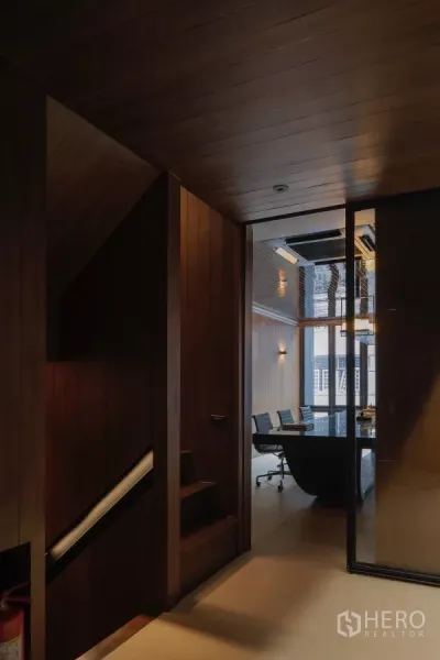 Office Space for rent in Bang Rak, Bangkok - Hallway with stairs leading to a glass‑enclosed meeting room