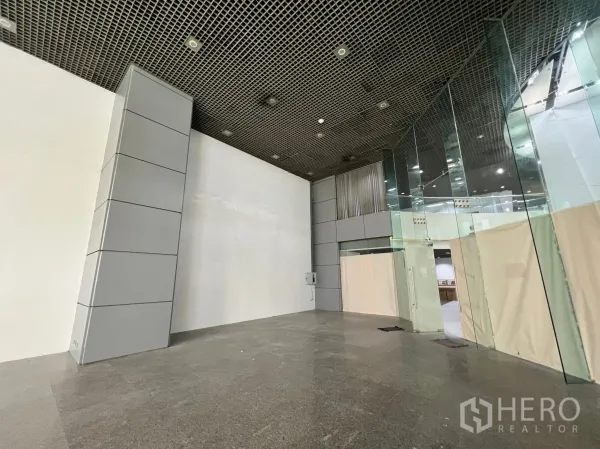 Retail Space for rent in Watthana, Bangkok - Shell retail interior with high ceiling, polished stone floors, and full-height glass partitions ready for fit-out.