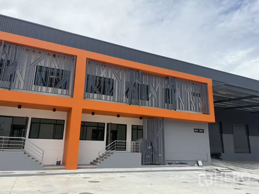 Factory for rent in Bang Pakong, Chachoengsao - Newly built factory exterior with bold orange facade and upper-floor offices in Bang Pakong.