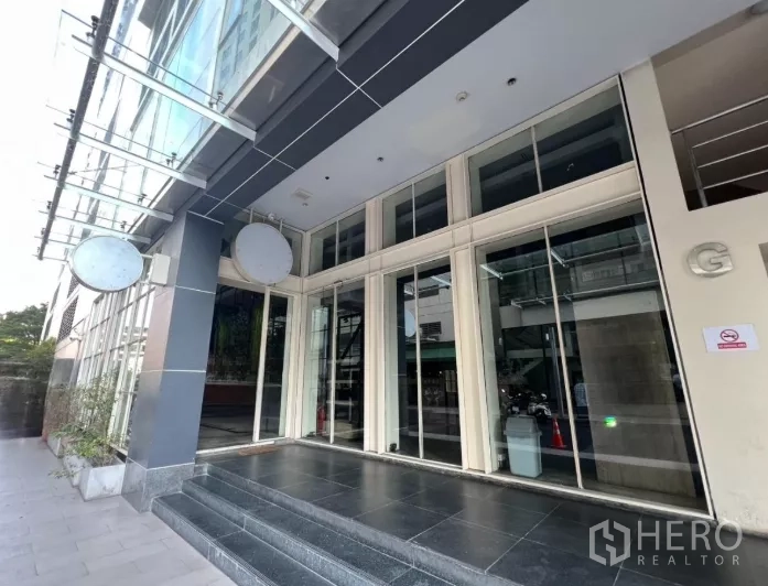 Retail Space for rent - Glass storefront entrance with wide steps and canopy, ideal retail frontage.