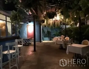 Retail Space for rent in Watthana, Bangkok - Evening patio with hanging greenery, string lights, and small dining tables.