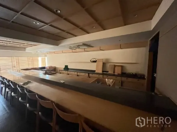 Retail Space for rent - Close view of fitted restaurant counter with wooden cabinetry and recessed lighting.