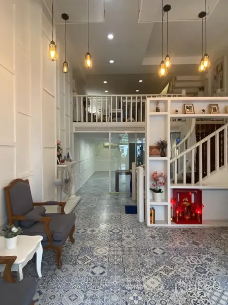 Retail Space for rent in Bang Rak, Bangkok - Bright shop space with mezzanine loft, decorative lighting, white paneled walls and patterned tile flooring.