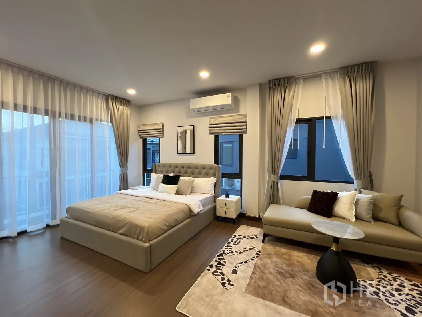 Detached House for rent in Bang Phli, Samut Prakan - Master suite view showing bed, seating area and hardwood floors.