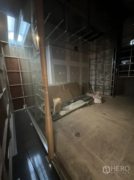Retail Space for rent in Watthana, Bangkok - Unfinished retail unit interior with high ceiling, drywall, and construction materials.